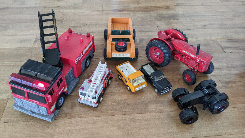 Lot of kids' fire trucks, tractors, and truck toys for sale  