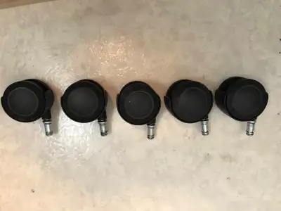 Set of five black swivel casters for chairs. They are 2 3/8” diameter with 7/16” shank. They are of...