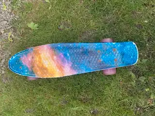 Multi colour fish scale skate board with flashing wheels, size is 22 inches long.Supports weight up...