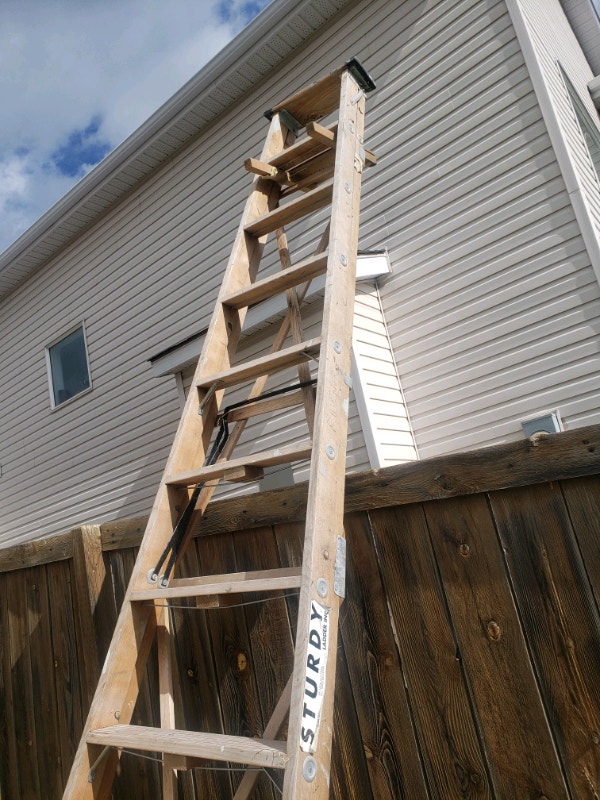 Ladder. 12 foot wooden ladder . Made by sturdy Ladders & Scaffolding