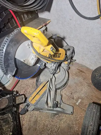 Selling a dewalt 12" sliding mitre saw It's in a rough shape but still cuts really good Everything w...