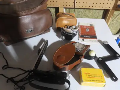 Photography equipment and case including a Kodak Auto-Release shutter times. From the 1950s. One fam...