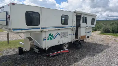 The Basics: Make/Model: 1999 TrailManor 2720SL (Highly sought-after "Slide-out Living" floorplan) We...