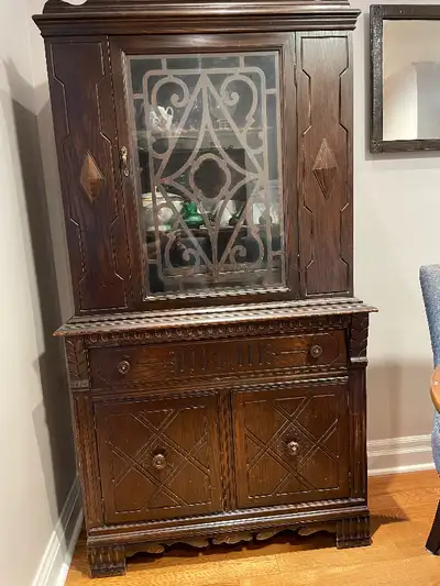 Glass door. Solid wood. Fits in small room. Great storage for your stuff. Sturdy hutch. 1920s. Show...