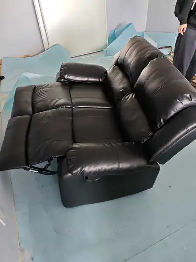 Selling a gently used black faux leather manual recliner chair in excellent working condition. - Fea...