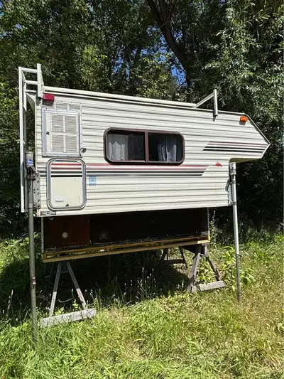90’s kenkraft camperette 8ft with half bunk Super light on my f-150 I would guess maybe 1000lbs Slee...