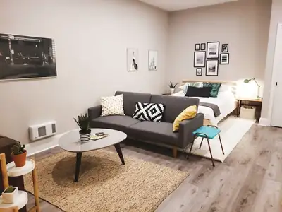 This inviting space features a sleek kitchen, a comfortable living area, and a well-appointed bathro...