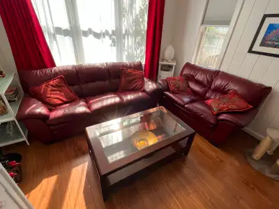 Very comfortable 3 seater leather couch and two seater leather love seat in burgundy red, plus wood...