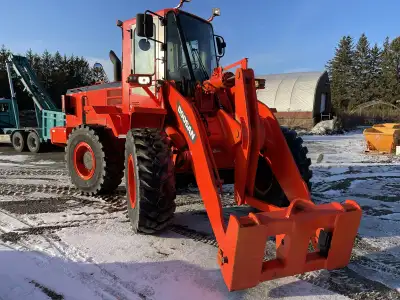 I'm selling a Doosan wheel loader with a quick attachment and 5,700 hours on it, perfect for various...