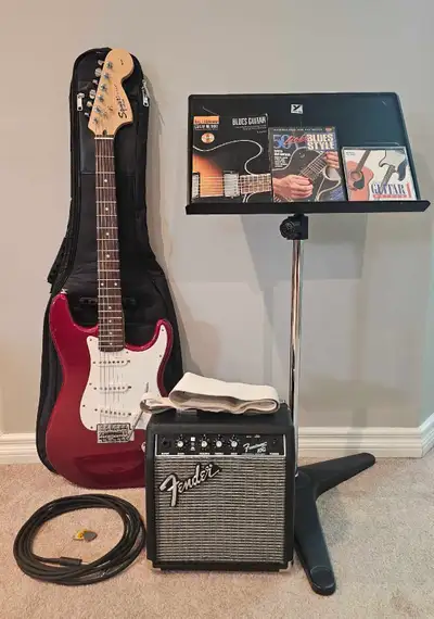Selling a Fender Squier Affinity Series stratocaster guitar set that includes the guitar, case, amp,...