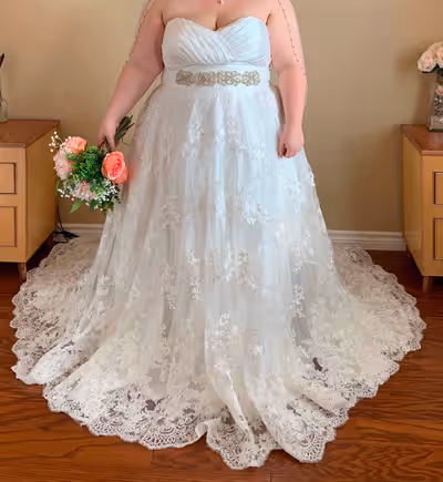 New with tags wedding dress with veil, tried on never worn, size 24 but can easily be altered remova...