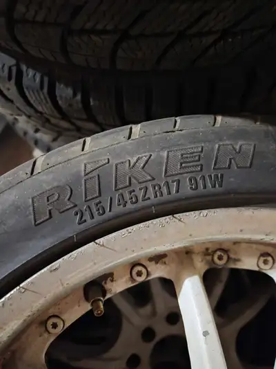 Aftermarket white rims. Four bolt. I forgot the bolt patteren but had them on a chevy cobalt and hon...