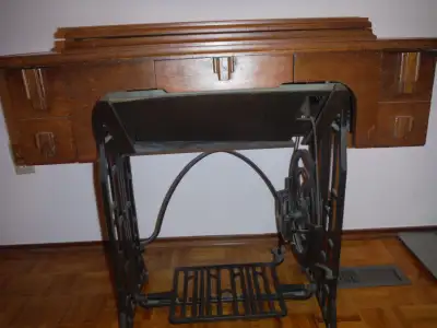 Reliance Treadle sewing machine with cabinet. Bought from T. Eaton & Co. in April, 1949. Has certifi...