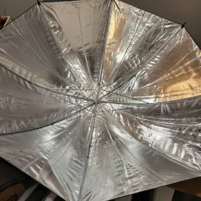 New unused studio reflector umbrellas for flash photography or lighting. White can be used to shoot...