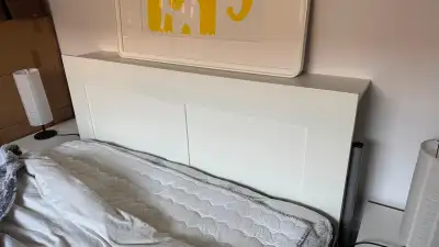 Selling this white BRIMNES headboard with hidden storage compartments – a smart solution for small b...