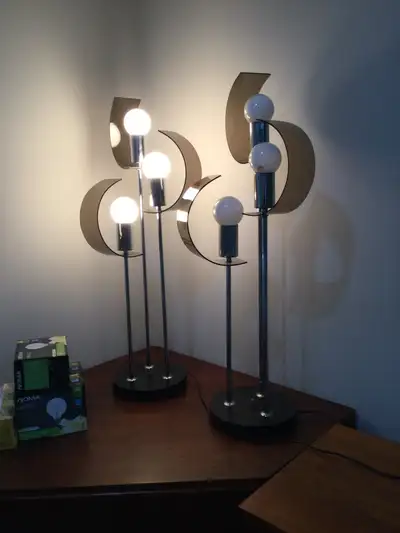 Pair of mid-century modern atomic lamps. Lucite curved lenses, one has a minor hairline crack. Extra...