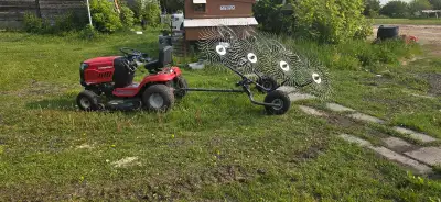 I have a tow behind folding wheeled grass rake for sale. When folded out it rakes about a 8ft wide p...