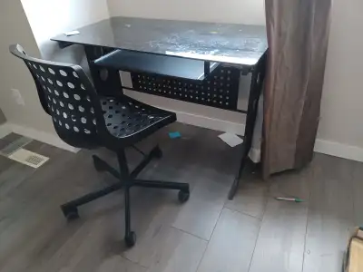 Used office desk. Glass top. Sliding tray. Adjustable height chair. Asking $60 for both.