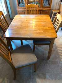 Solid oak dining room table (with leaf) and 4 chairs