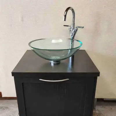Modern vanity with glass bowl sink and Delta faucet in good working condition. Great for a taller pe...