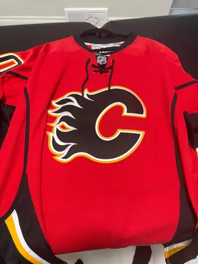 Signed Calgary Flames NFL Reebok Jersey. Has the Canada and Alberta flag on the sleeves, player is T...