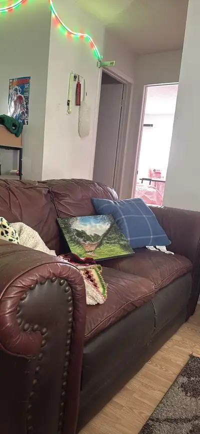 Brown leather loveseat couch, View more