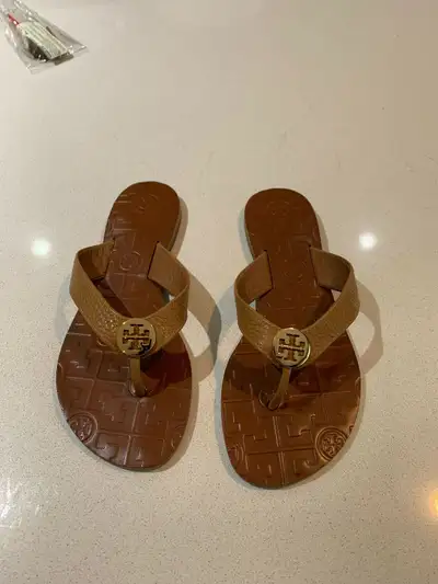 Bought in Florida and never used Tori Burch flip flop sandals, can be casual or dressy. Chocolate br...