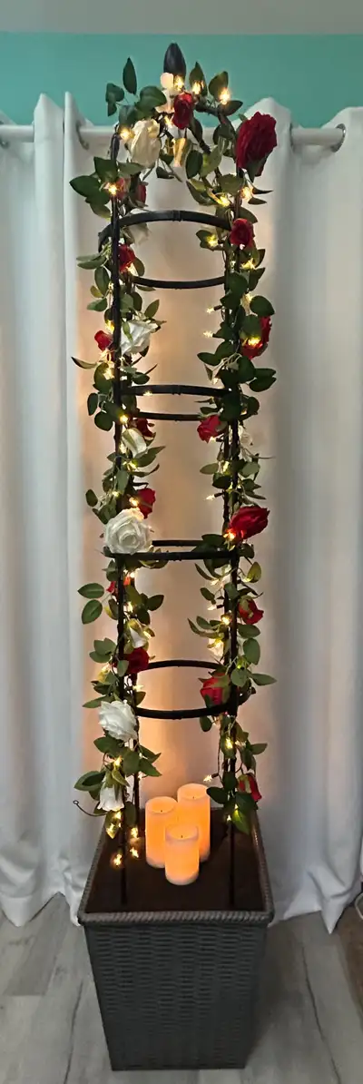 Measure seven feet tall. Includes artificial roses and fairy lights. There are two identical towers....