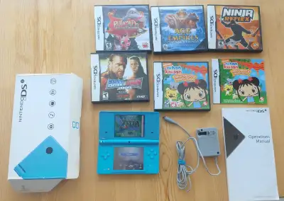 Working Nintendo DSi with charger, box, manual, and black stylus. Has vertical lines on the top scre...