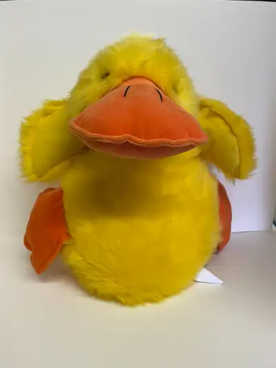 Large yellow plush duck with orange bill and feet, and satin flower bow -Excellent condition with ta...