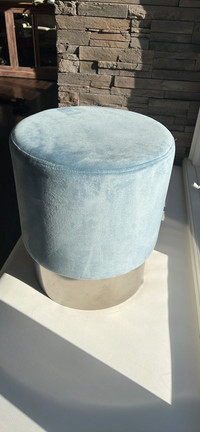 Soft round velour padded stool/foot rest. Soft blue with chrome.