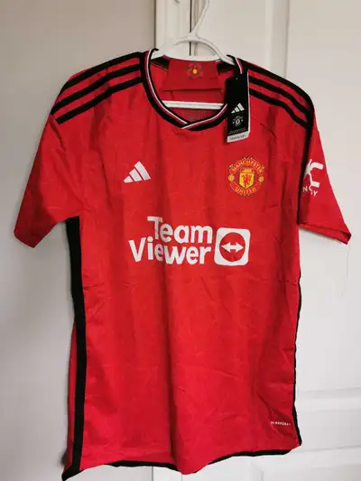 Get ready to show your support with this brand new Adidas Manchester United 2021-2022 home jersey! T...
