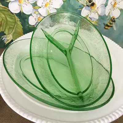 This set includes two vintage 1930s green uranium depression glass oval shaped serving dishes. Flore...
