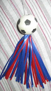 Rubber like soccer ball with ribbons.