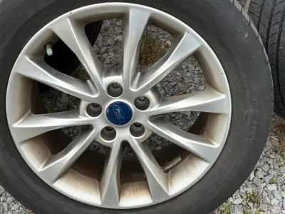 A set of rims (tires are worn). Came off 2017 Ford Fusion. Has working TPMS in all of them. One rim...