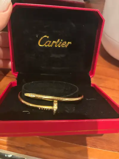 Gold-Tone Cartier Style Nail Bracelet with Crystals Presented in a red Cartier-branded box, this ele...