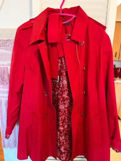 This is a red trench coat, perfect for adding a pop of colour to your wardrobe while staying stylish...
