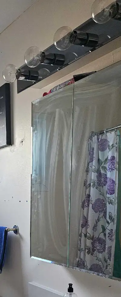 bathroom mirrored vanity and light fixture. , View more