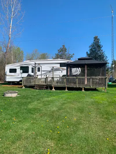 Trailer comes with large deck, screened patio, patio furniture, Bbq/wood smoker, shed, firewood. All...