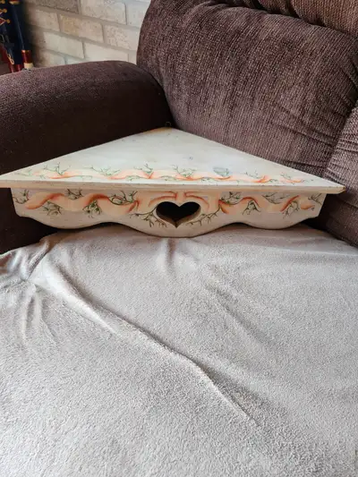 Hand painted wooden corner shelf. 21" long x 14" each side. Hanging hook attached.