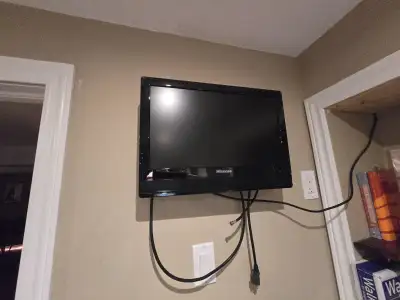 Barely Used wall-mounted TV with mount, View more