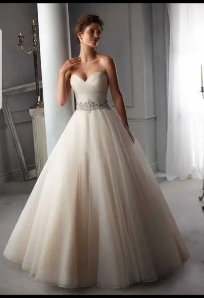 Brand new Ivory Morilee wedding dress available. The dress has off the shoulder sleeves and a corset...