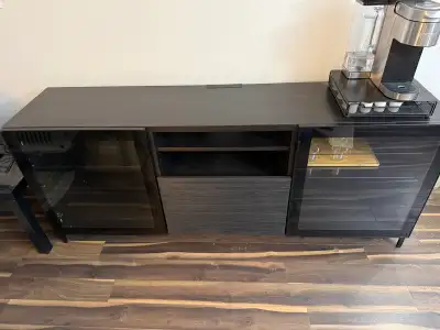 This is an IKEA TV stand in used condition, but still has plenty of life left. It features a dark wo...