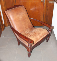 Pair of leather upholstered, padded plantation chairs w/ ottoman