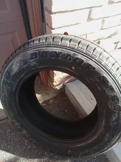 Dunlop all season tire size P215/65R16 with lots of tread left. Perfect as a spare or to replace a s...