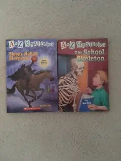Up for sale are two used A-Z Mysteries Books: - The School Skeleton - Sleepy Hollow Sleepover Booth...