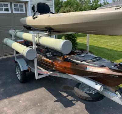 Two 12’ Wilderness Fishing Kayaks. One is ATAK 120 and the other is TARPON 120. Trailer is Malone Mi...
