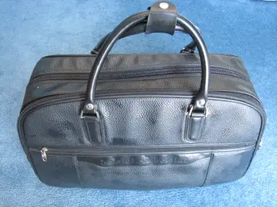 Black Leather, carry on bag with 2 rollers, new never used., View more