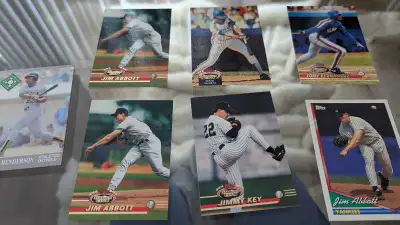 These are a set of used baseball cards. The cards feature players such as Jim Abbott, Ricky Henderso...
