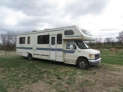 Smooth ride! This is an older motorhome, but it runs great and has so much potential. Features seati...
